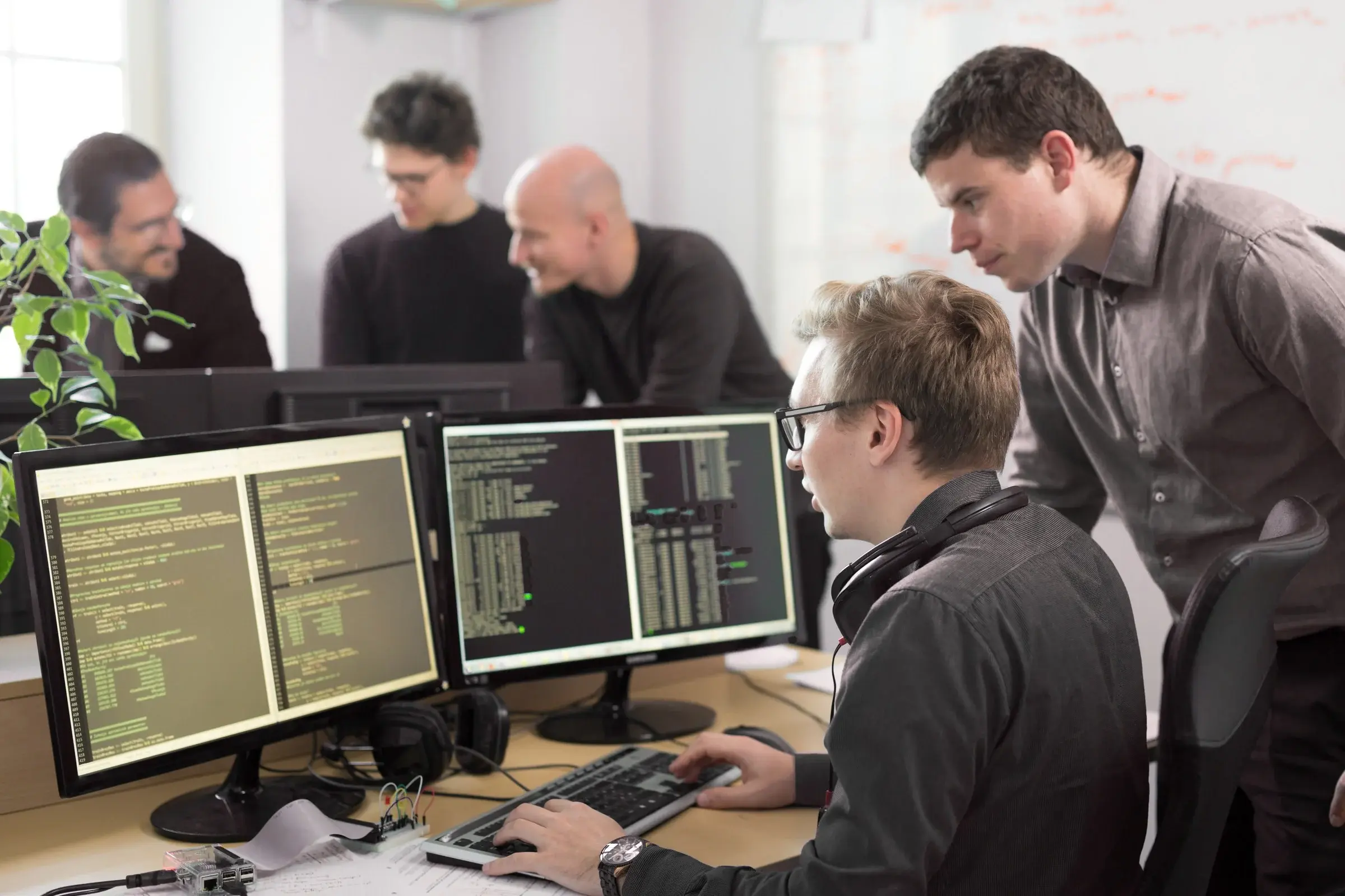 man looking at computer screen in office